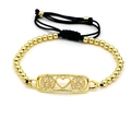 Detalle de la pulsera de cuentas doradas con colgantes de caritas y cordón negro - Estilo Sonriente (S7)