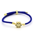 Detail showing hand-woven blue nylon cord and gold flower charm with blue cubic zirconia - Blue Braided Flower Smiley (B3)