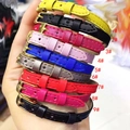 Detail of colorful slim leather bracelets with gold buckles shown in nine vibrant shades - Yellow Leather Style (1#)