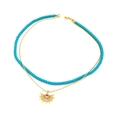 Detail of double-layer necklace with blue beads and sunburst pendant with red crystals - Double Layer Blue Bead Sunburst Style (218)