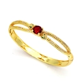 Detalle de brazalete tejido dorado con piedra central roja y micro-pavé de diamantes blancos - Serpientes Dobles