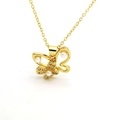Detailed close-up of golden butterfly pendant with white pearls and sparkling crystals - Butterfly Style (C6)