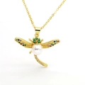 Macro view of gold dragonfly pendant with colorful zircons and a white pearl on wings - Dragonfly Style (C5)