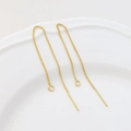Macro shot of 18K gold-plated needle-style ear chains with open jump rings for DIY jewelry - 14K Gold