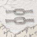 Macro shot of silver plated jewelry connectors with cubic zirconia for DIY bracelets - White Gold