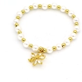 Close-up of pearl beaded bracelet with gold flower charm and sparkling crystals - Transparent Flower (4998188008257) / White