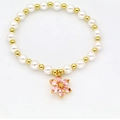 Detail of beaded bracelet with white pearls, gold beads and a pink flower pendant - Pink