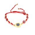 Close-up of red woven Evil Eye bracelet with gold beads and LOVE engraved pendant - Love Pattern Round Style (07)