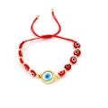 Red woven evil eye bracelet featuring a central blue eye charm with gold serrated edges - Red Eye Beads Style (O1)