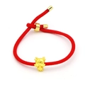 Close-up of a red braided zodiac dragon bracelet with a gold-colored charm and adjustable knot - Dragon Bead Style (A)