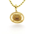 Detailed macro shot of gold coin pendant with red stones and French engraving - Double Circle Cross Medallion (A2)