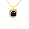 Macro view of gold pendant with emerald-cut black gemstone and pave-set zircons - Black