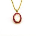 Detail of gold religious necklace with red baguette gems and white oval relief pendant - Red