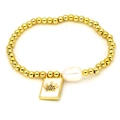 Detail of gold bead bracelet featuring white square crown tag and large baroque pearl - Crown