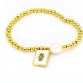 Golden beaded bracelet with irregular pearl and white enamel Hamsa hand charm - Hamsa Hand