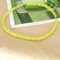 Detail of yellow agate beaded necklace with silver magnetic clasp on fabric - Yellow
