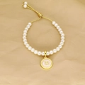 Detail of pearl bracelet with golden letter B pendant and adjustable sliding clasp - Letter B
