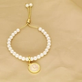 Detail of beaded pearl bracelet with adjustable gold slide clasp and letter C pendant - Letter C