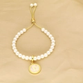 Detail of pearl bracelet featuring an adjustable gold closure and pink letter D pendant - Letter D