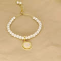 Chic pearl bracelet with adjustable golden slider and pink letter F round pendant - Letter F