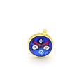 Detail of round golden pendant featuring traditional blue Thangka mask and meander patterns - Blue Totem (A2)