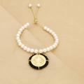 Fashionable faux pearl bracelet with golden Virgin Mary pendant on silk background - Black (C1)