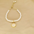 Detail of white pearl bracelet with gold adjustable slider clasp and letter X pendant - Letter X