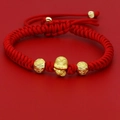 Macro view of hand-woven red cord bracelet with golden zodiac snake charm and lucky beads - Money Bag Snake Charm (C) / Red & Gold