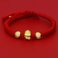 Macro view of a red woven zodiac rabbit bracelet with gold beads and Fu character - Fu Tag Zodiac Rabbit (D) / Red & Gold