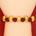 Detailed close-up of red agate beads and golden snake charms on a festive bracelet - Red Agate Zodiac Monkey Style (A3)