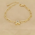 Macro detail of gold paperclip chain bracelet featuring a zircon-encrusted letter A pendant - Letter A