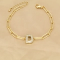 Macro detail of 18k gold paperclip chain bracelet with a sparkling zircon letter D charm - Letter D