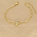 Macro shot of 18k gold paperclip chain bracelet with a sparkling zircon letter F pendant - Letter F