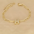 Close-up of 18k gold paperclip chain bracelet with a pavé zircon letter H pendant - Letter H