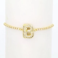 Detailed view of 18k gold tennis bracelet featuring a micro-pave zircon letter B charm - Letter B