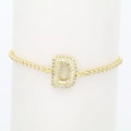 Macro view of gold-plated bracelet featuring a zircon-encrusted capital letter D pendant - Letter D