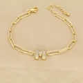 Macro detail of paperclip chain bracelet with a gold M letter pendant inlaid with zircons - M