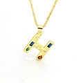 Macro detail of gold-plated H-letter pendant with colorful zircon stones on rope chain - Letter H