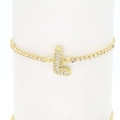 Macro view of 18k gold letter L bracelet with sparkling cubic zirconia on white pillar - Letter K