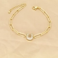 Detailed view of golden paperclip bracelet with a sparkling zircon letter U pendant - Letter U