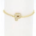 Macro shot of gold tennis bracelet with a crystal-encrusted letter P charm on a display - Letter P