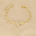 Detailed macro view of 18k gold paperclip chain bracelet with zircon pavé letter V pendant - Letter V