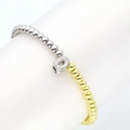 Macro detail of 18k gold and silver beads bracelet with a sparkling zircon letter Q charm - Letter Q