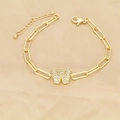 Macro detail of gold paperclip chain bracelet with zircon pavé letter W pendant - Letter W
