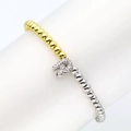Detailed macro view of 18k gold plated stretch bracelet with zircon inlaid letter R charm - Letter R