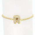 Detail of 18k gold plated tennis bracelet featuring a micro-paved zircon letter R charm - Letter R