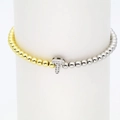Detailed macro of 18k gold plated beads bracelet featuring a pavé zircon letter T charm - Letter T