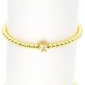 Detailed close-up of 18k gold elastic bead bracelet with micro-pave cubic zirconia letter A - Letter A