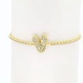 Detailed close-up of 18k gold V-letter pendant with zircon inlay on a tennis bracelet - Letter V