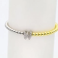 Detail of beaded bracelet with gold and silver spheres and zircon-studded letter W charm - Letter W